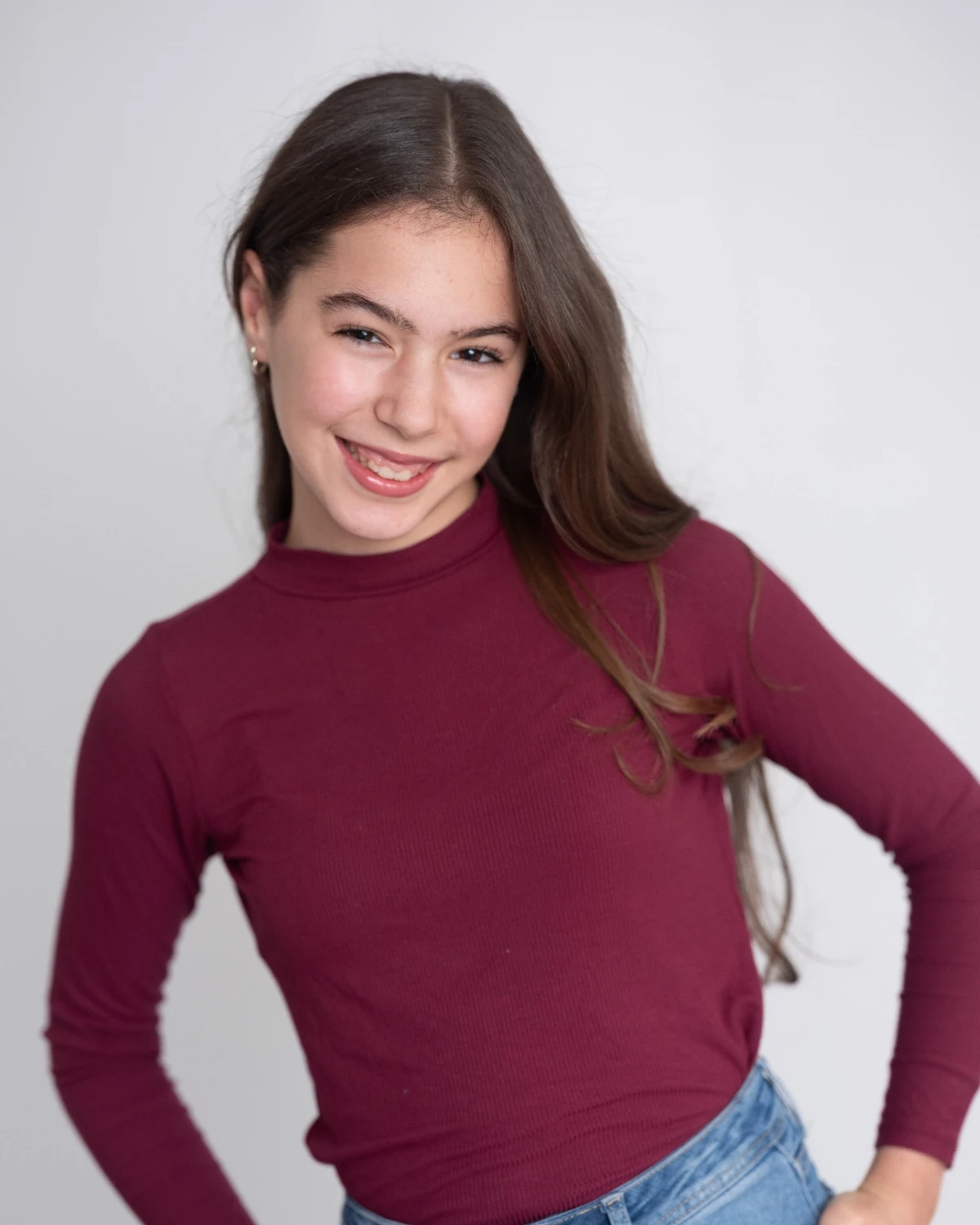 Samara smiling in a burgundy top